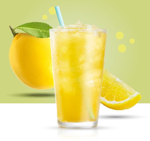 Sparkling Green Tea Lemonade. Caribou BOUsted caffeinated beverages Lemons and green background behind the drink