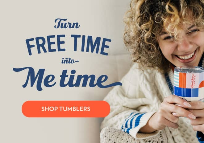 Turn Free Time into Me Time. Shop Tumblers. Woman holding a Caribou Coffee Mug