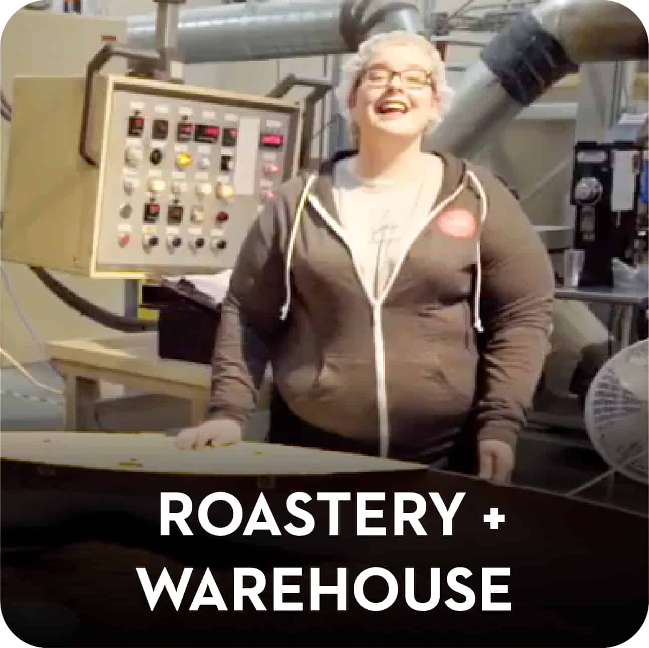 Woman smiling in a roastery. Roastery Warehouse