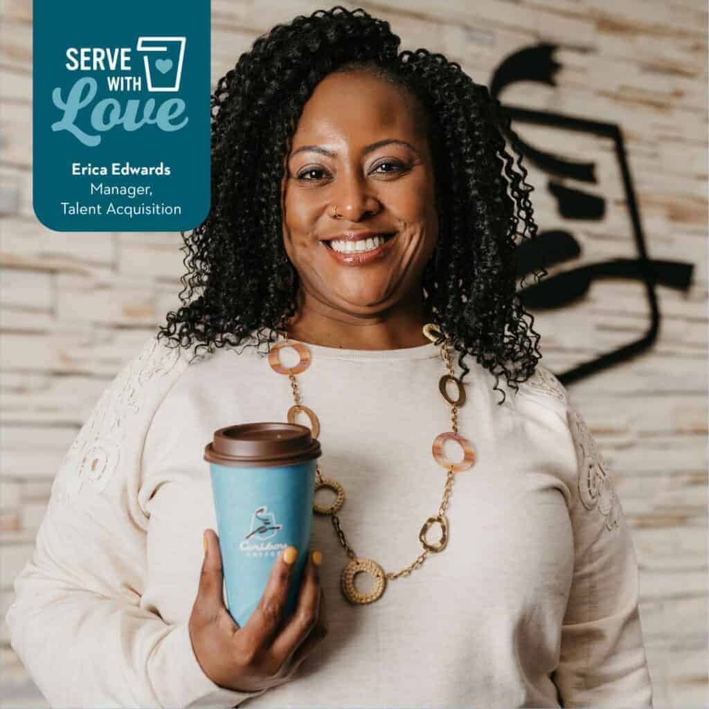 Headshot of Manager of Talent Acquisition, Erica Edwards smiling and holding a cup of Caribou Coffee