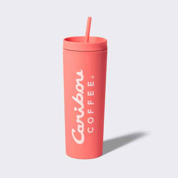 Pink silicone tumbler with a straw and a caribou coffee logo. Buy one now.