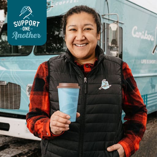 Headshot of Sara Edgren smiling and holding a cup of Caribou Coffee