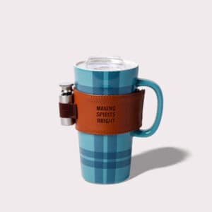 Blue and black tumbler mug with a flask. Flask has a leather clutch that says making spirits bright.