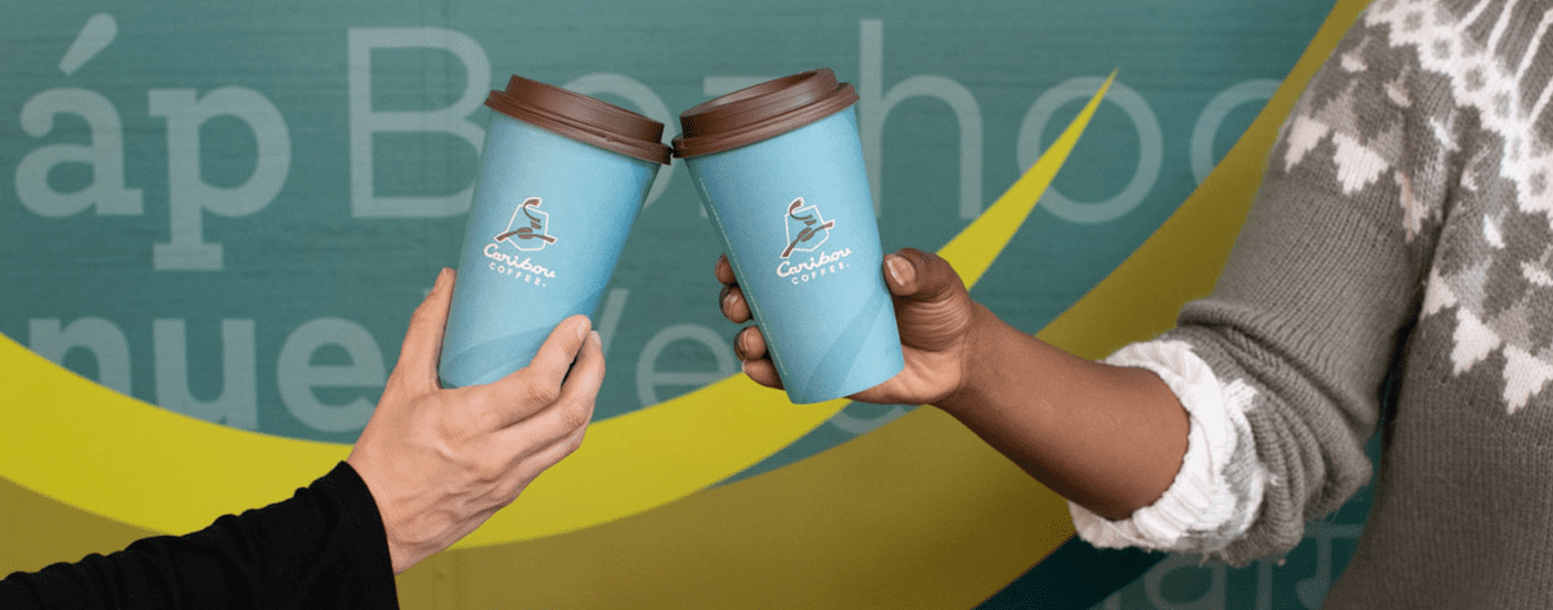 two caribou coffee cups cheersing at second harvest heartland