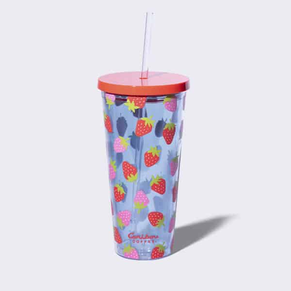 Clear tumbler with red strawberries and a straw.