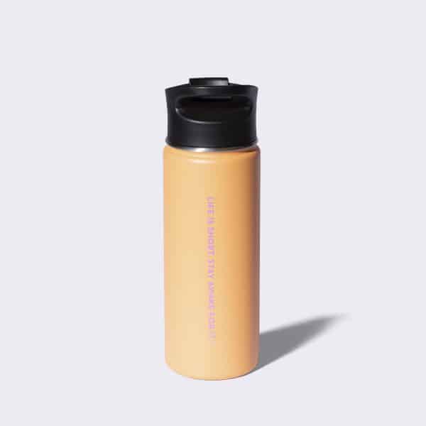 Orange stainless steel tumbler with a life is short stay awake for it watermark on the back of it.