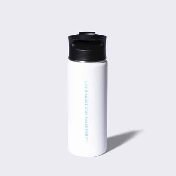 White stainless steel tumbler with a life is short stay awake for it watermark on the back of it.