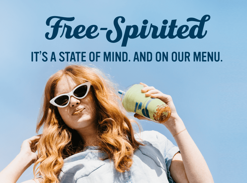 Free-spirited it's a stat of mind and on our menu. Woman smiling and holding a bubble drink. 