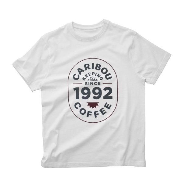 White Caribou Coffee shirt with Keeping You awake since 1992.