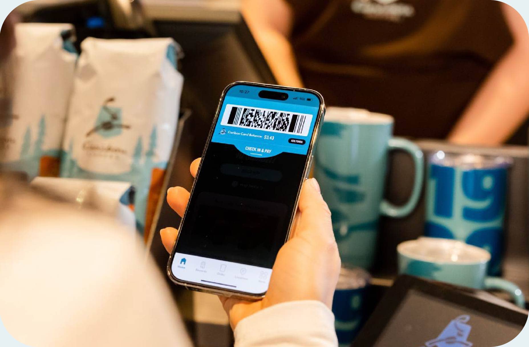 Person scanning the Caribou Coffee app