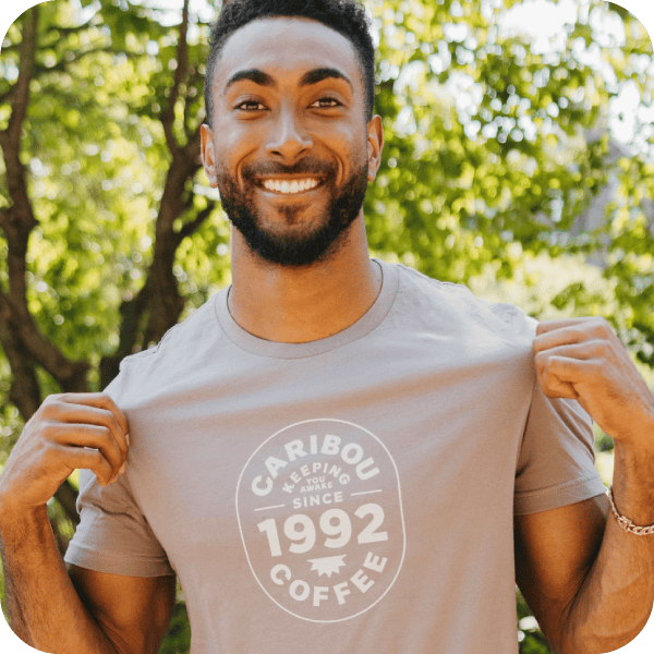 Man wearing a Caribou Coffee shirt