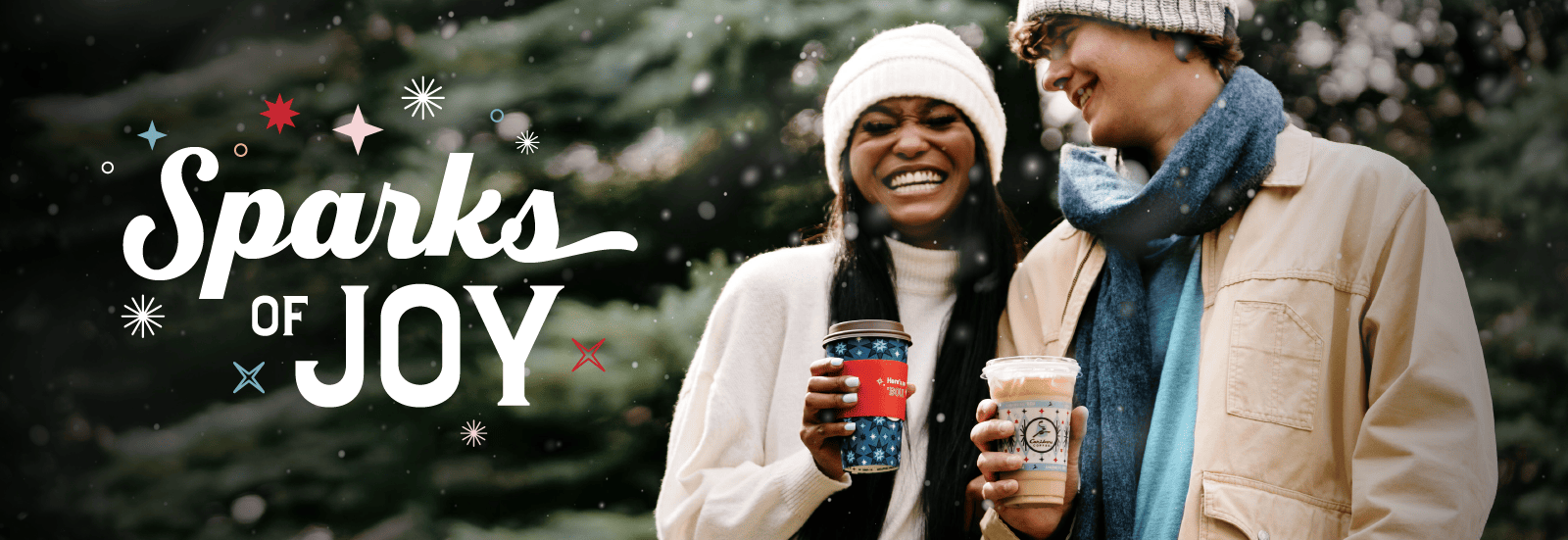 Sparks Joy. Two people smiling and holding caribou coffee.