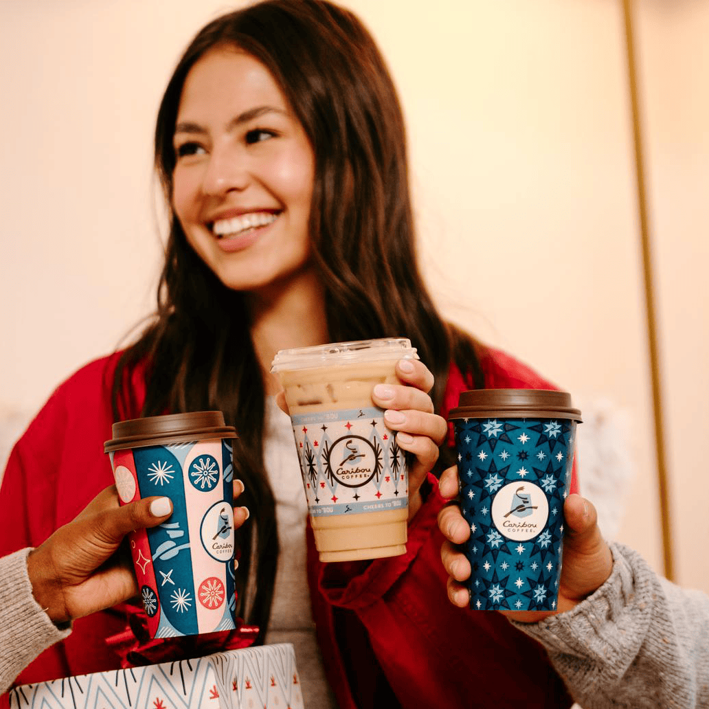 woman smiling with caribou coffee