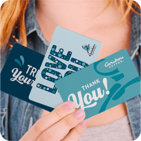 Woman holding multiple physical gift cards.