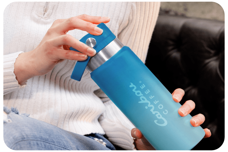 Women opening a blue ombre tumbler.