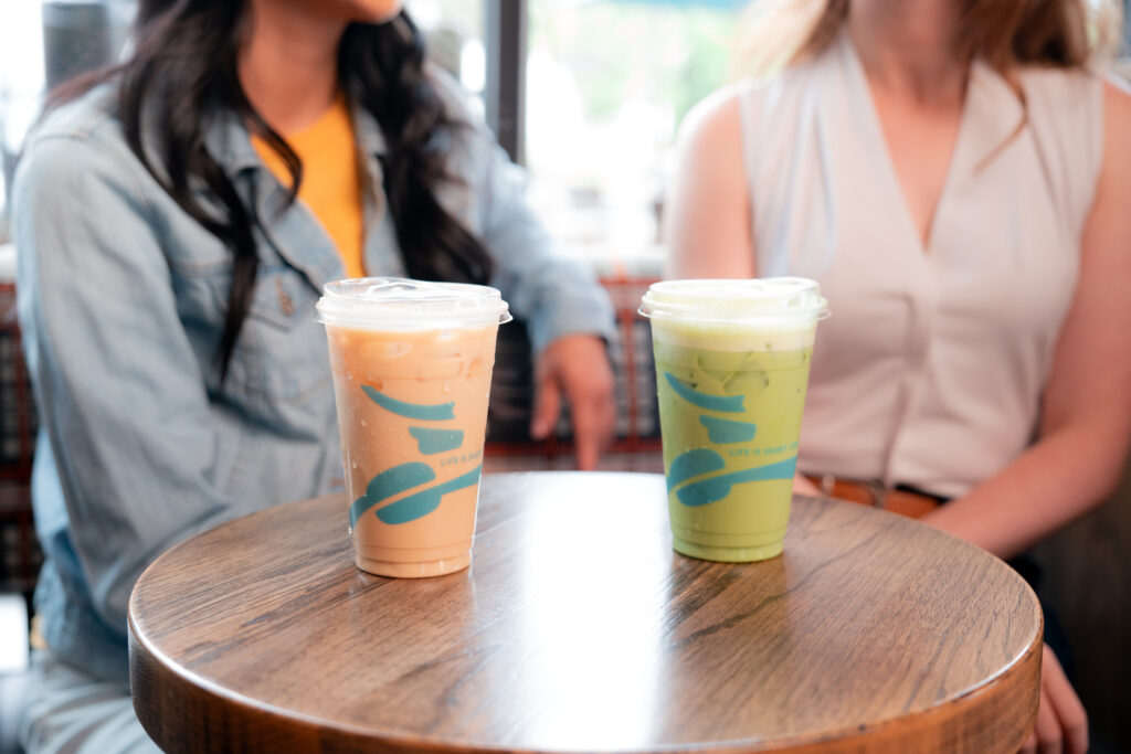 Table with two Caribou Coffee drinks sitting on it