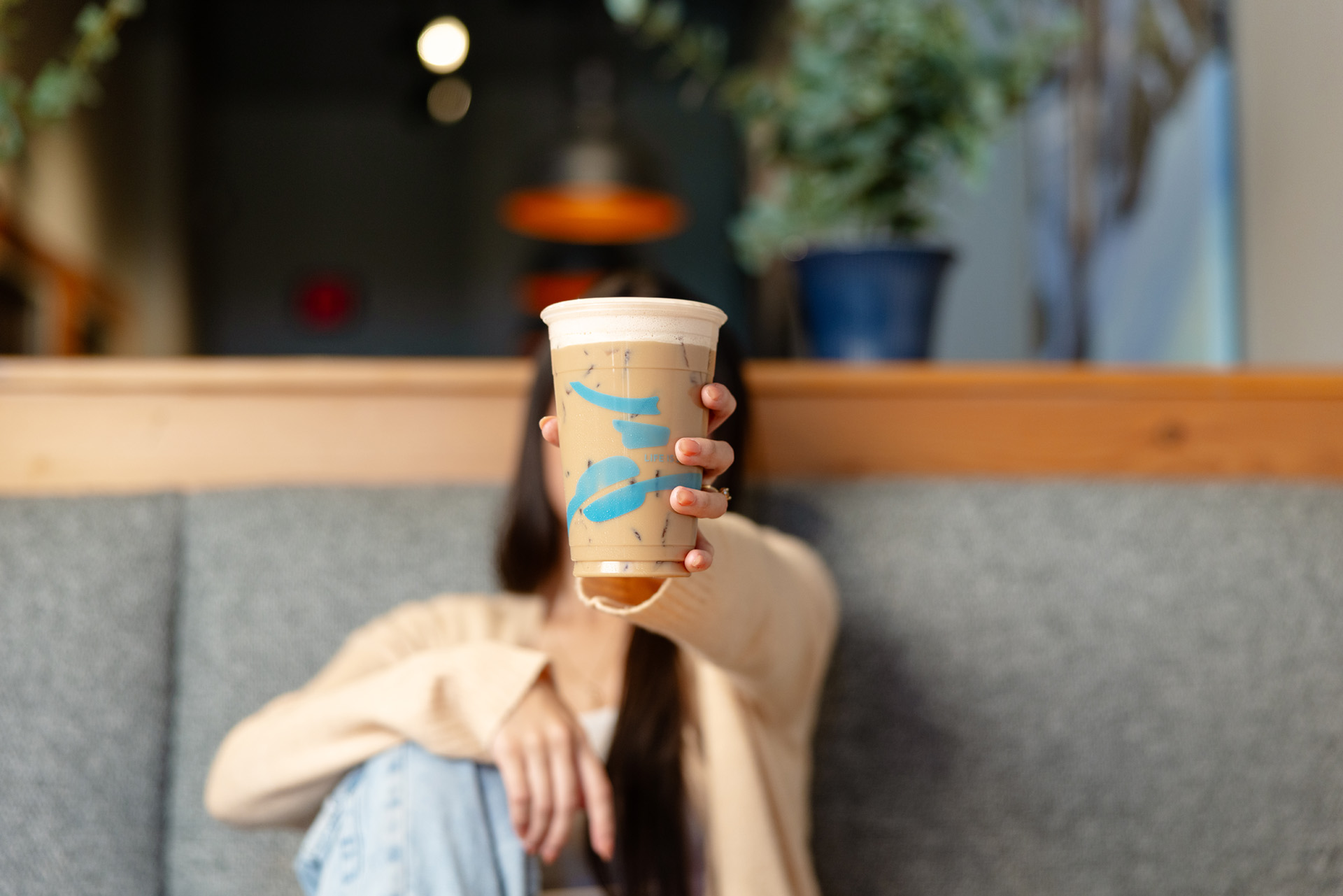 Person holding up a Caribou Coffee drink